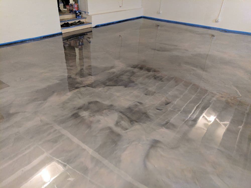 Glossy concrete floor with a polished finish, showcasing reflections and modern design.